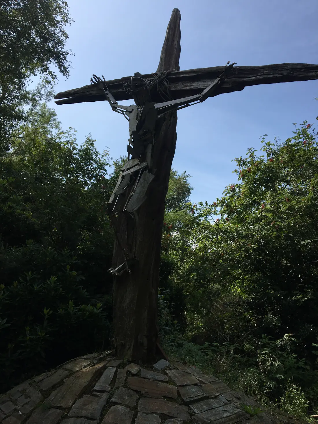 A large wooden crucifix set among trees
